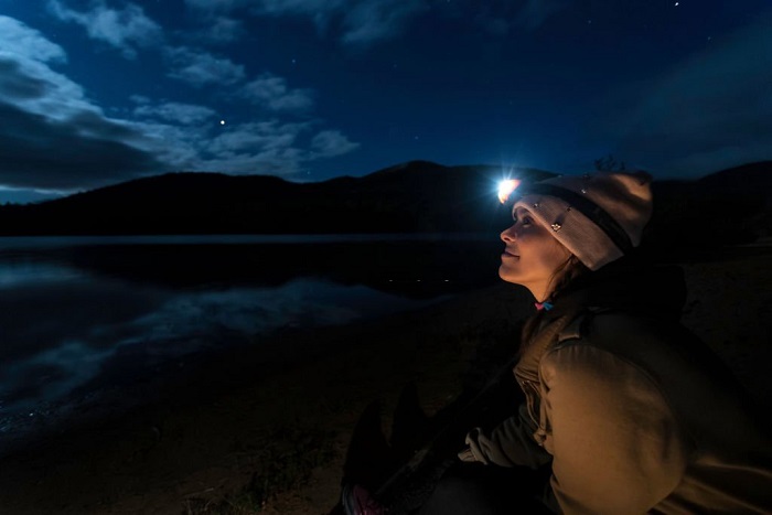 Anaya is looking at the clear sky at night in camping