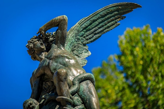 Close up of the Fountain of the Fallen Angel or Fuente del Angel Caido in the Buen Retiro Park in Madrid
