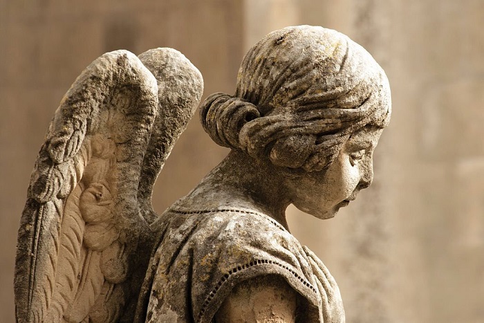 A 19th-century praying angel on a grave in Sicily, Italy, made by an unknown sculptor