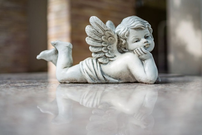 Vintage filter on Cupid sculpture close up