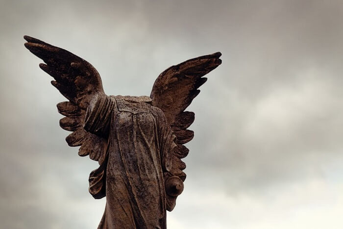 Angel statue on a 1920s grave in a cemetery