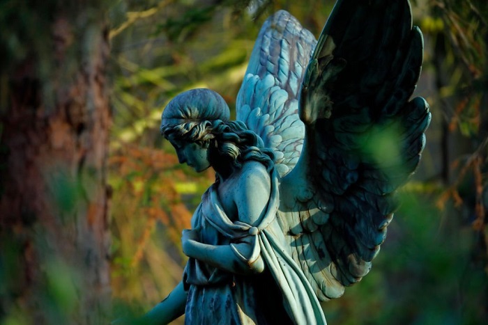 Old copper angel statue in a cemetery