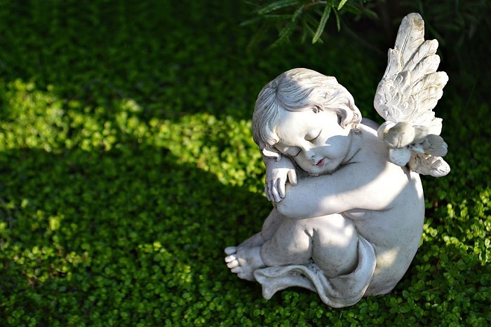 Little angel figurine on the grave