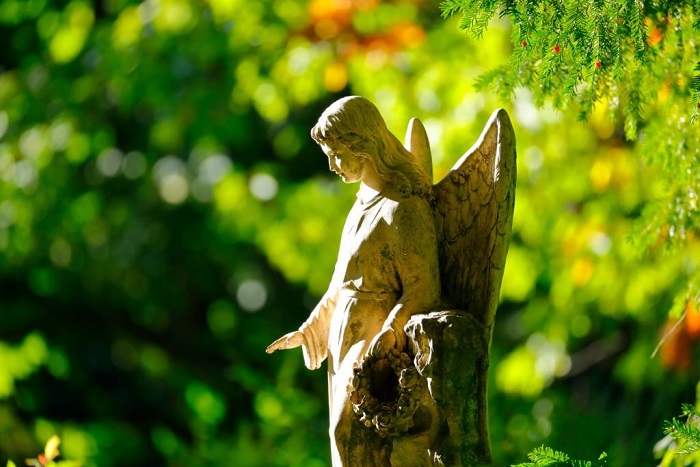 Weathered old angel statue in a cemetery