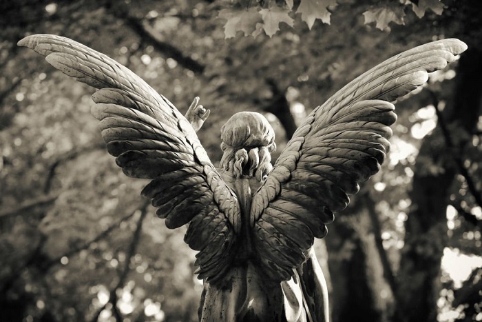 Weathered old copper angel statue at the Melaten Graveyard