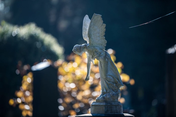 Stone statue of angel on a graveyard