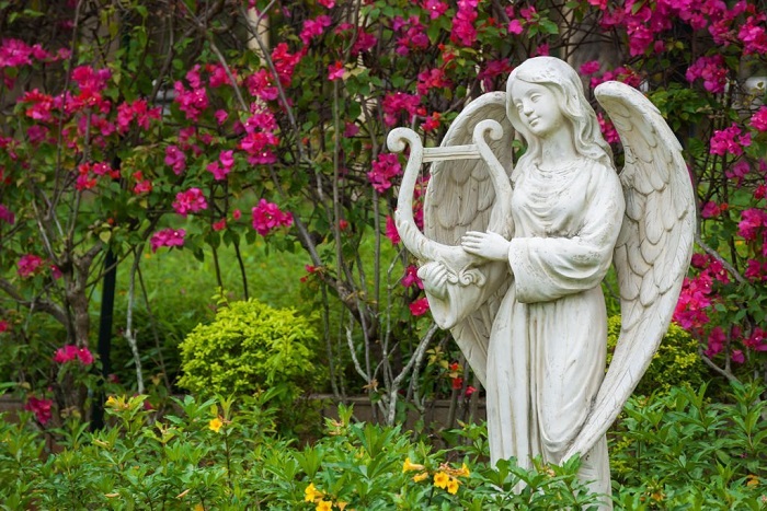 Sculpture of angel in flower garden