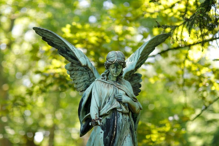  Weathered old angel statue in a cemetery in Germany