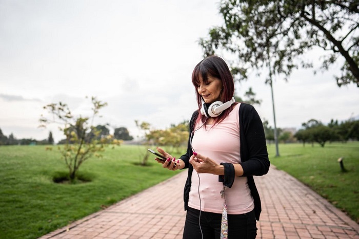 Gianna walking and using mobile phone at public park