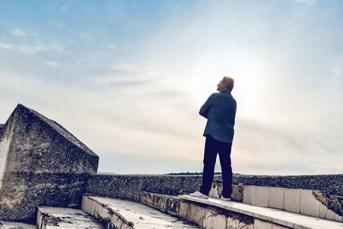 Jaxson Looking at the Sky Hopping for Better Future and Leaving the ruins of the city behind