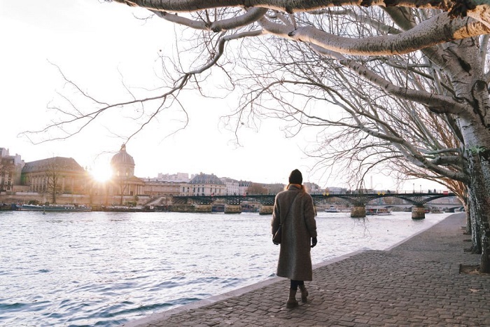 Julia walks along  Seine river in Paris, winter season December