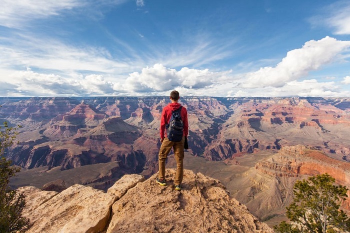 Travel in Grand Canyon, Kai with backpack enjoying view, USA