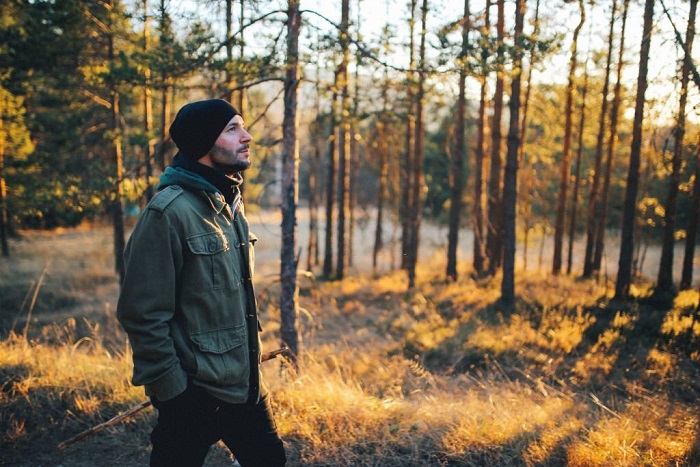 Vintage toned image of Michael walking in the beautiful nature, through the forest