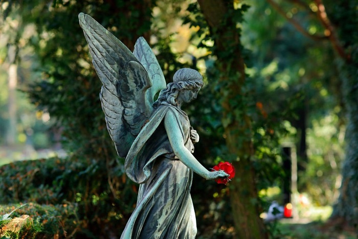 Walking angel sculpture on a cemetery
