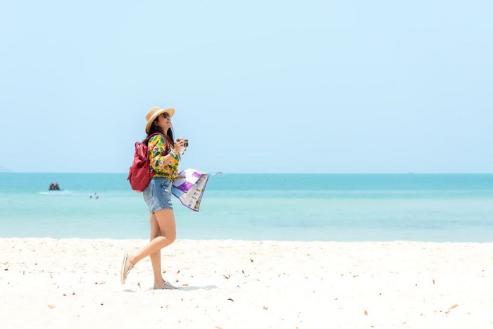 Happy traveler and tourism women travel summer on the beach