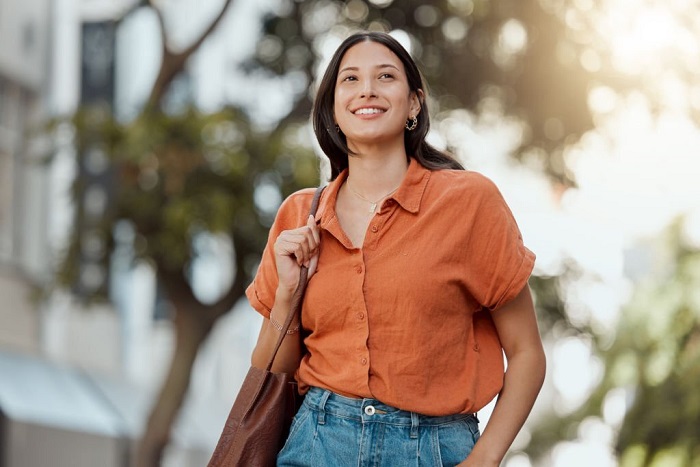 Stylish, happy and trendy student walking in a city, commuting to a college