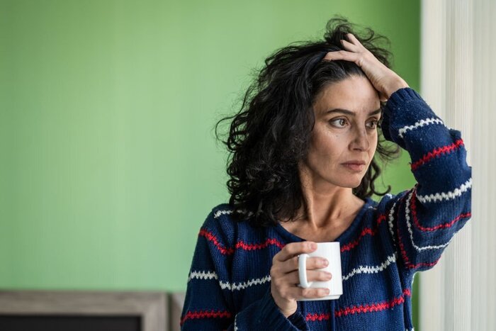 Woman drinking coffee at home, alone