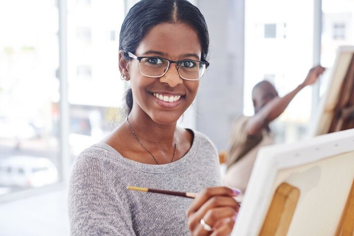 Source: Istockphoto. Cropped shot of a beautiful young woman painting in a art studio